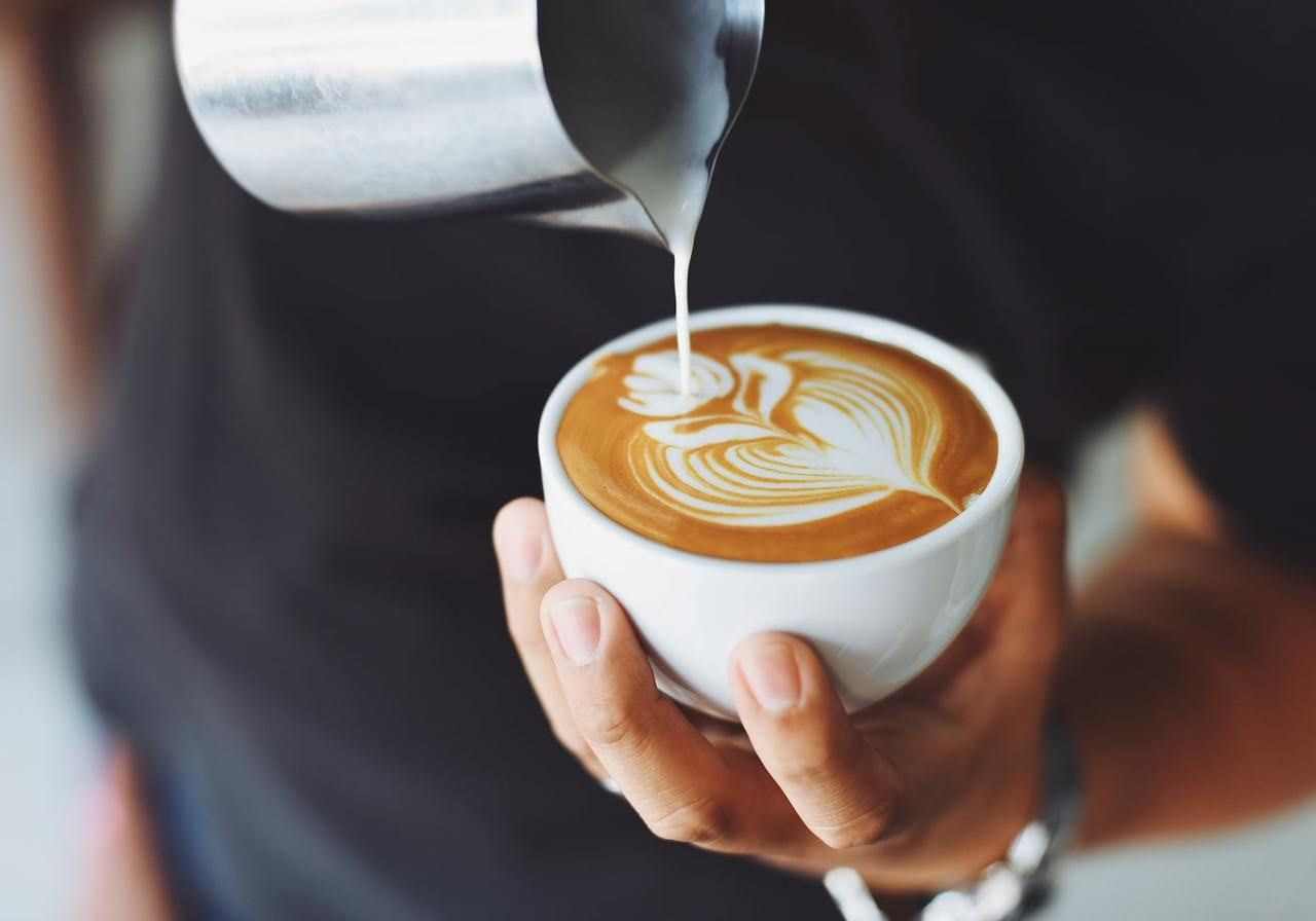 A person pouring a cup of coffee.