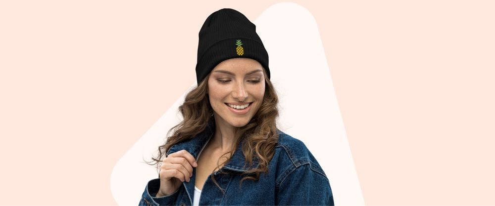 woman in a black beanie with an embroidered pineapple in front