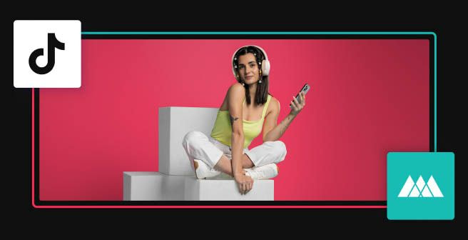 a woman sitting on a block with headphones on