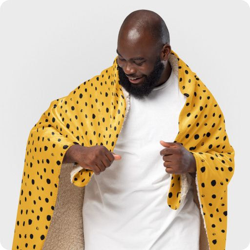 a man wearing a yellow and black blanket