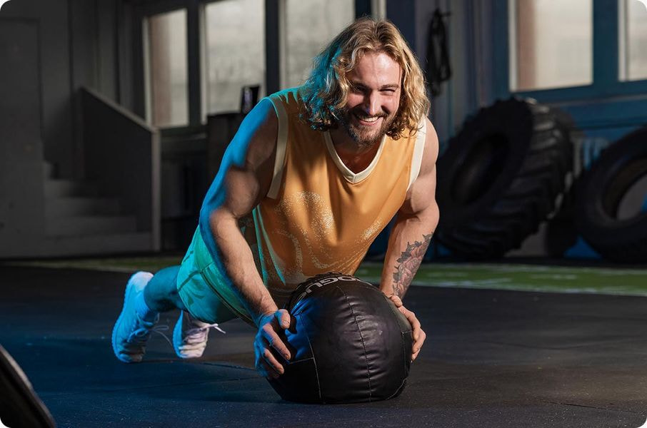 a man doing push ups with a medicine ball
