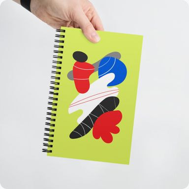 a hand holding a spiral notebook