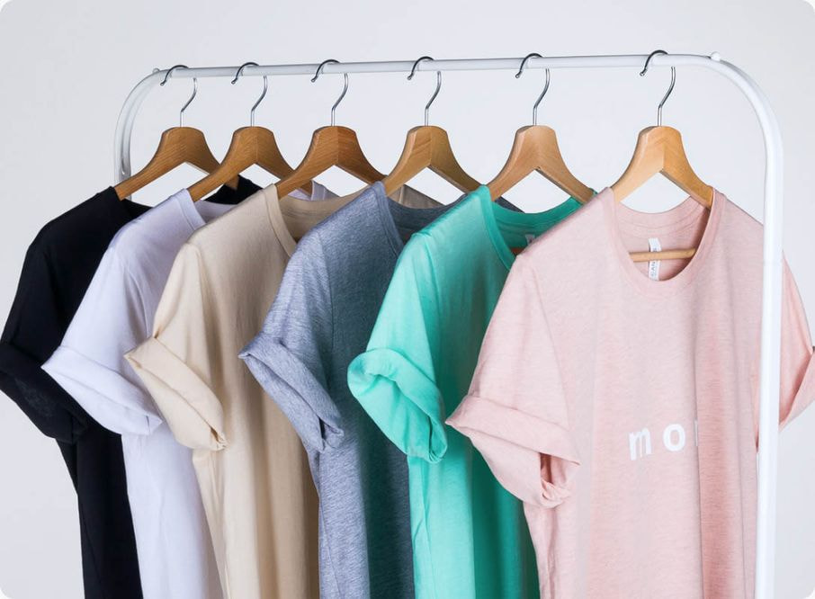 six t-shirts on hangers