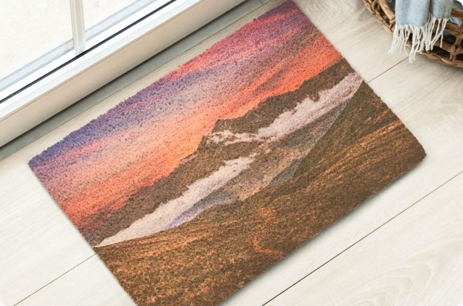 Custom doormat featuring a full-color landscape photograph of mountains at sunset, demonstrating photo-quality print capabilities.