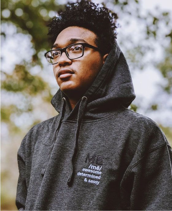 a man wearing glasses and a hoodie