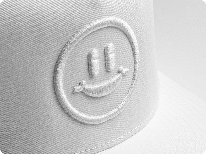 White thread smiley face 3D puff embroidery on white hat