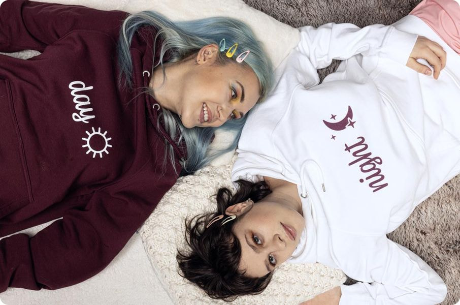2 women wearing custom hoodies