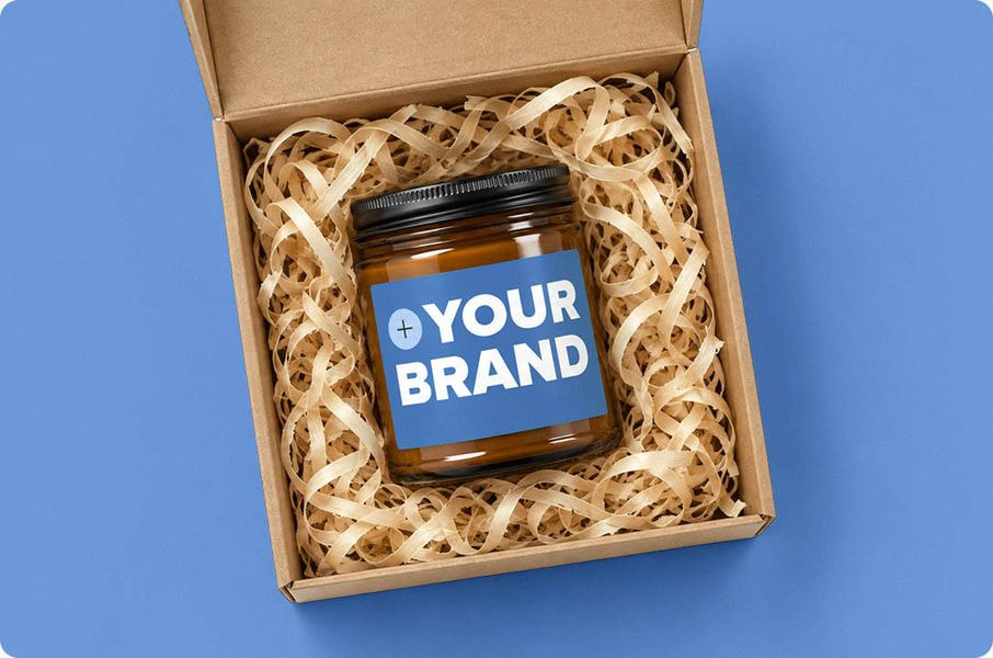 Branded candle packaged in a gift box.