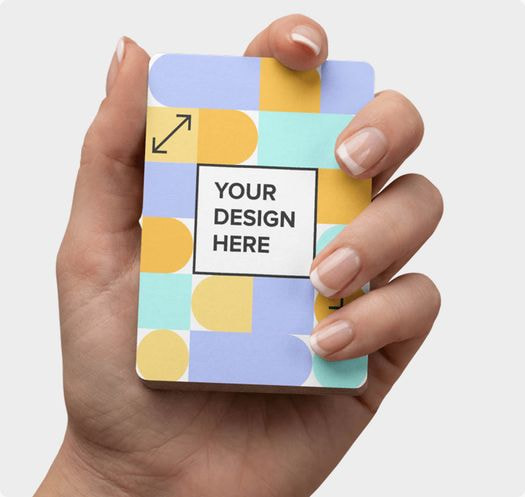 Close-up of a hand holding a custom playing card featuring a colorful geometric design and placeholder artwork, showcasing the premium print quality and customization options available for personalized card decks.