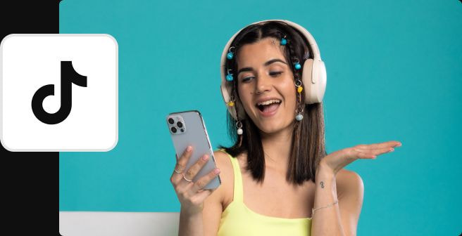 a woman wearing headphones and holding a phone