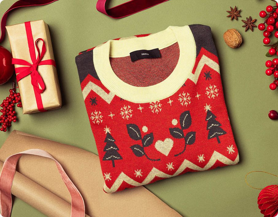 a red and white sweater with snowflakes and hearts on it