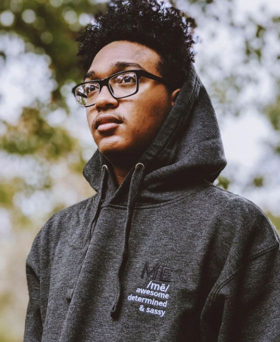 a man wearing glasses and a hoodie