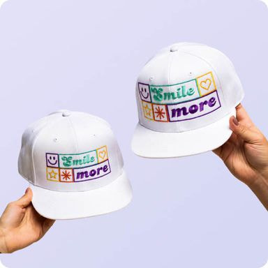 two hands holding hats with text