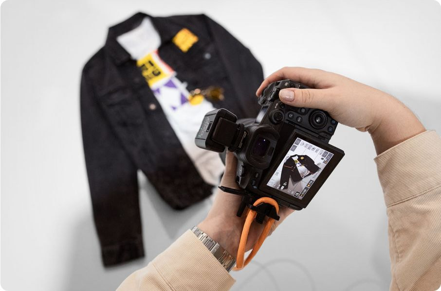 a hand holding a camera