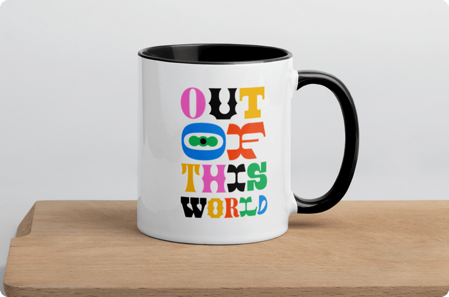 White mug with black handle featuring colorful 