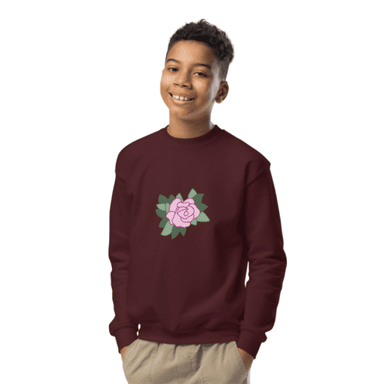 a boy wearing a maroon sweatshirt with a flower on it