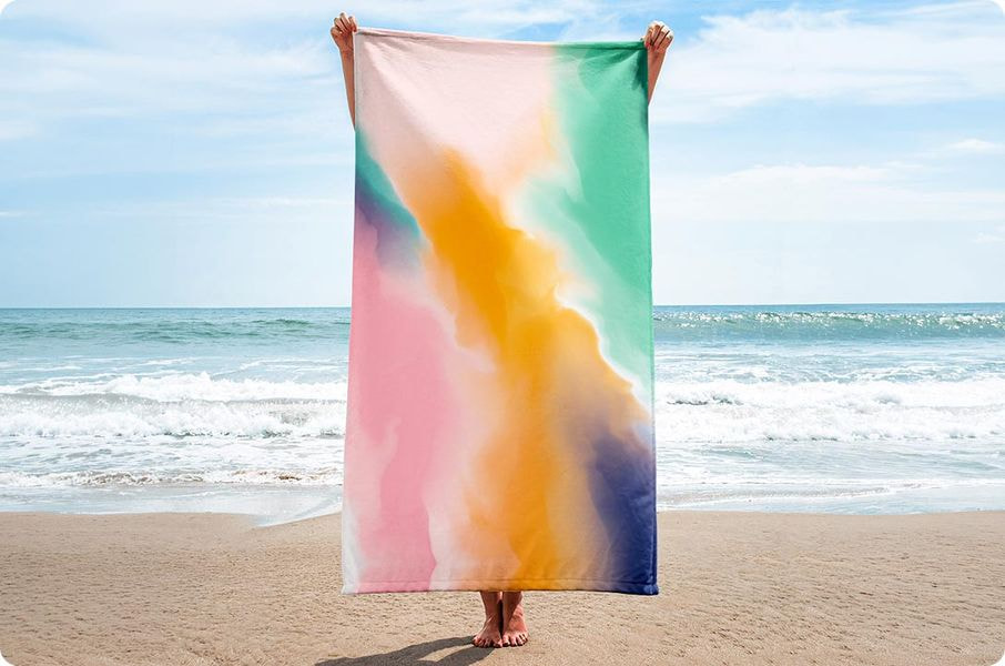 a person holding a blanket on a beach