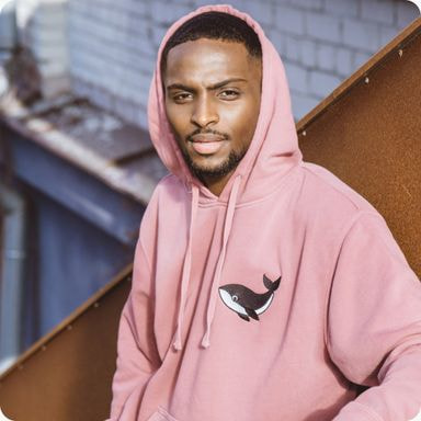 a man wearing a pink hoodie