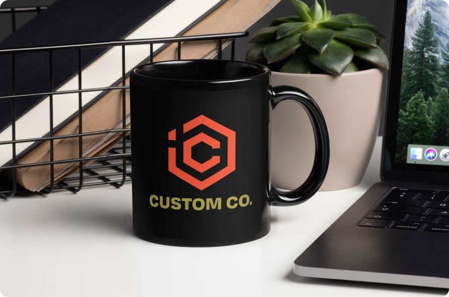 a coffee mug next to a laptop