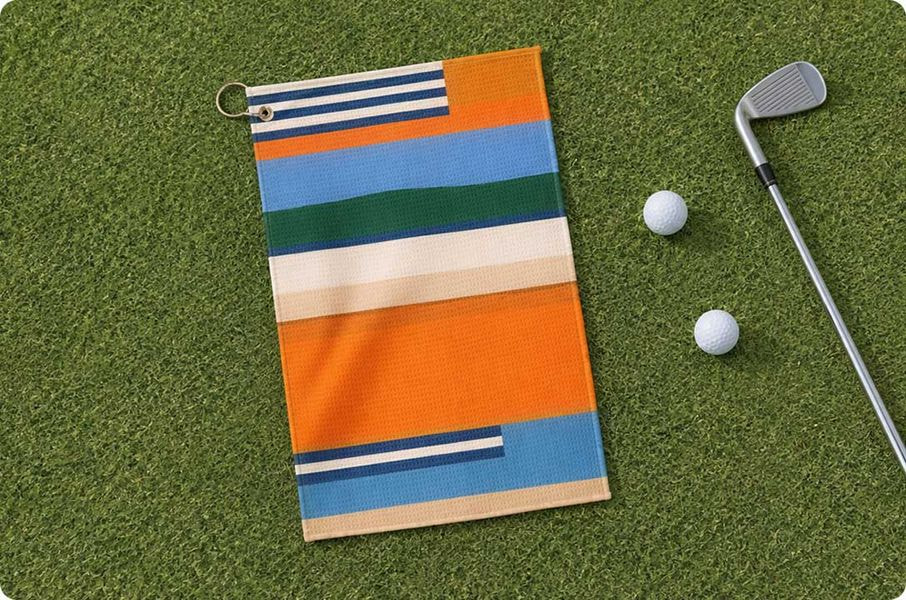 a towel and golf balls on a green grass