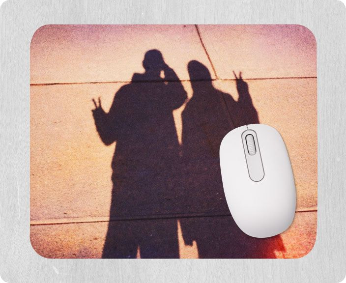Custom photo mouse pad featuring a sunset image of two people’s shadows making peace signs, shown with a white mouse.