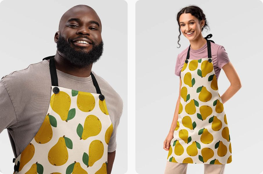 Two people wearing aprons with yellow pear pattern design.