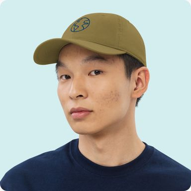 man wearing green baseball cap looking directly at the camera