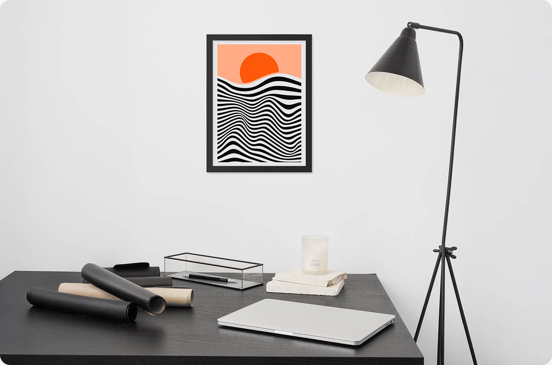 a desk with a laptop and a lamp